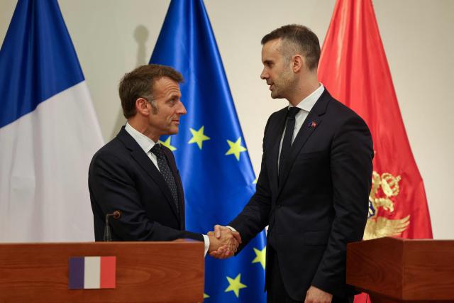 France's President Emmanuel Macron (L) and Montenegro's Prime Minister Milojko Spajic shake hands after delivering a statement following a signing ceremony during Macron's first official visit to Montenegro in Cetinje on June 4, 2026. (Photo by Ludovic MARIN / AFP)
