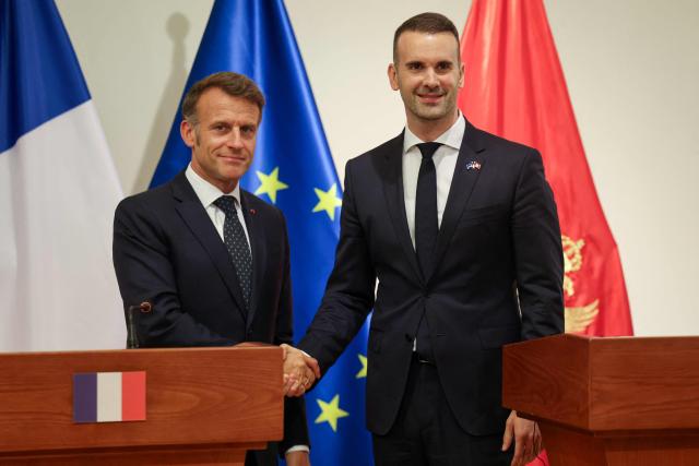 France's President Emmanuel Macron (L) and Montenegro's Prime Minister Milojko Spajic shake hands after delivering a statement following a signing ceremony during Macron's first official visit to Montenegro in Cetinje on June 4, 2026. (Photo by Ludovic MARIN / AFP)