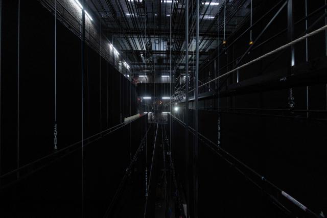 Stagehand Jeremie Strauss poses backstage at the National Theatre of the Opéra Comique where he assembles theatre sets before, during and after performances in Paris on June 1, 2026. (Photo by JOEL SAGET / AFP)