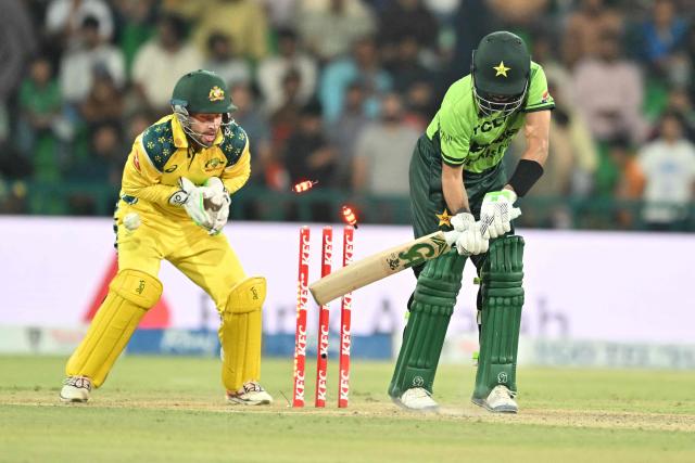 Pakistan's Babar Azam (L) bowled by Australia's Matthew Kuhnemann during the third one-day international (ODI) cricket match between Pakistan and Australia at Gaddafi Stadium in Lahore on June 4, 2026. (Photo by Arif ALI / AFP)