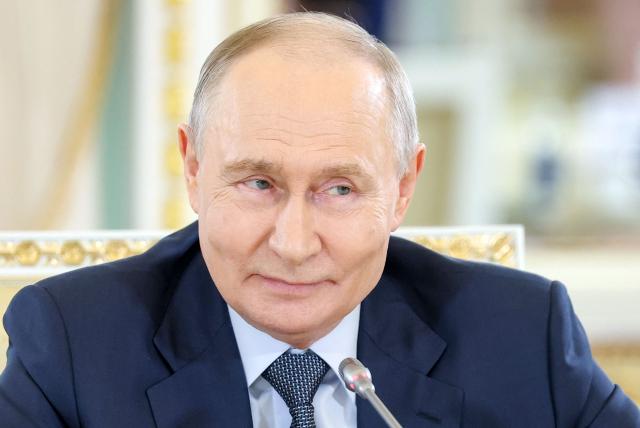 In this pool photograph distributed by the Russian state agency Sputnik, Russia's President Vladimir Putin meets with representatives of international news agencies on the sidelines of the St. Petersburg International Economic Forum at the Constantine Palace in Saint Petersburg on June 4, 2026. (Photo by Valery SHARIFULIN / POOL / AFP)