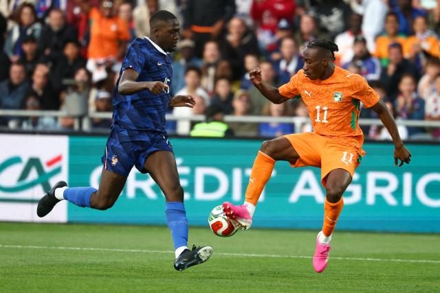 France's defender #15 Ibrahima Konate (L) and Ivory Coast's forward #11 Yan Diomande (R) fight for the ball during the international friendly football match between France and Ivory Coast ahead of the 2026 FIFA World Cup football tournament at the Stade de la Beaujoire in Nantes, western France, on June 4, 2026. (Photo by FRANCK FIFE / AFP)