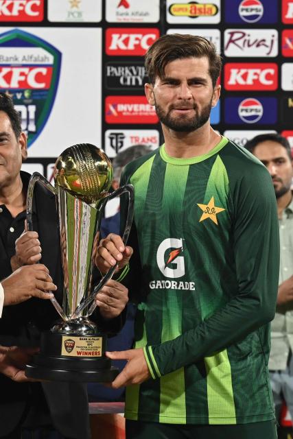 Pakistan's captain Shaheen Shah Afridi poses with the Winners' trophy after winning the third One Day International (ODI) cricket match between Pakistan and Australia at the Gaddafi Stadium in Lahore on June 5, 2026. (Photo by Arif ALI / AFP)