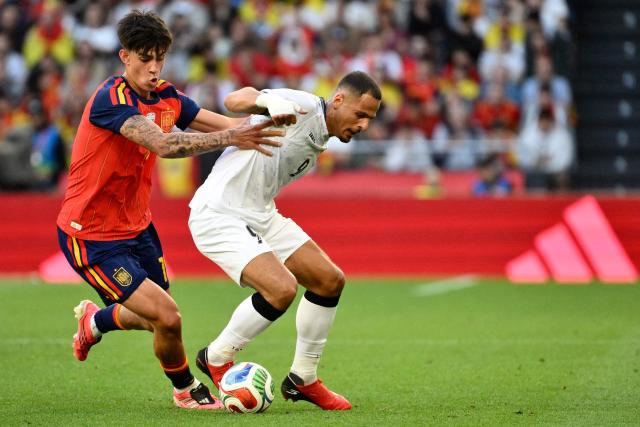 Spain's midfielder #18 Marc Bernal (L) and Iraq's forward #09 Ali Al-Hamadi fight for the ball during the international friendly football match between Spain and Iraq ahead of the 2026 FIFA World Cup football tournament, at the Riazor stadium in A Coruna, northern Spain, on June 4, 2026. (Photo by Ander Gillenea / AFP)