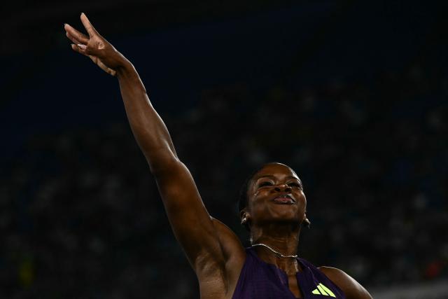 Jamaica's Megan Simmonds celebrates after winning the women's 100m Hurdles during the IAAF Diamond League athletics meeting, at the Olympic Stadium, in Rome on June 4, 2026. (Photo by Filippo MONTEFORTE / AFP)