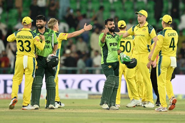 Pakistan's players Shadab Khan (centre-R) and Abdul Samad (2nd L) shake hands with Australia's players as they celebrate after winning the third One Day International (ODI) cricket match between Pakistan and Australia at the Gaddafi Stadium in Lahore on June 5, 2026. (Photo by Arif ALI / AFP)