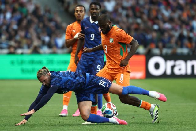 France midfielder #14 Adrien Rabiot is tackled by Ivory Coast's midfielder #08 Franck Kessie during the international friendly football match between France and Ivory Coast ahead of the 2026 FIFA World Cup football tournament at the Stade de la Beaujoire in Nantes, western France, on June 4, 2026. (Photo by FRANCK FIFE / AFP)