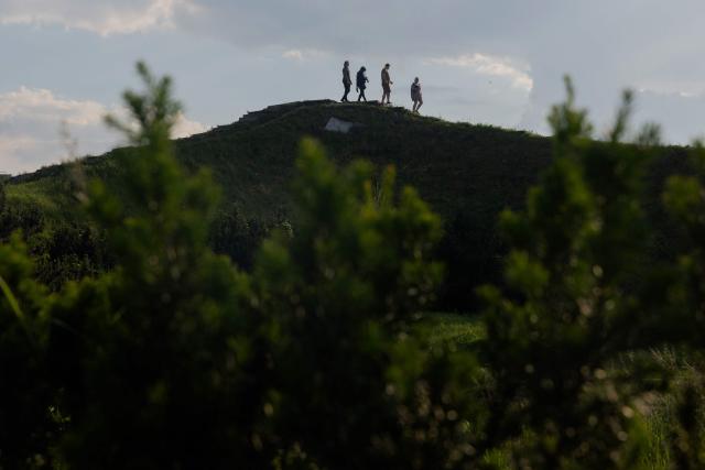 Local residents walk through the botanical garden in Kyiv on June 4, 2026, amid the Russian invasion of Ukraine. (Photo by Tetiana DZHAFAROVA / AFP)