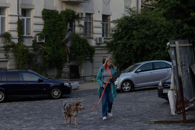 A local resident walks their dog in Kyiv on June 4, 2026, amid the Russian invasion of Ukraine. (Photo by Tetiana DZHAFAROVA / AFP)