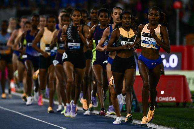 Bahrain's Winfred Yavi (R) competes in the women's 5000m during the IAAF Diamond League athletics meeting, at the Olympic Stadium, in Rome on June 4, 2026. (Photo by Filippo MONTEFORTE / AFP)