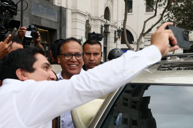 A supporter of Peru's presidential candidate for the Juntos por el Peru party Roberto Sanchez (C) attempts to take a selfie as he leaves following a press conference in Lima on June 4, 2026. Right-wing candidate Keiko Fujimori and leftist Roberto Sanchez will face off in Peru's presidential runoff on June 7, 2026. (Photo by Connie FRANCE / AFP)