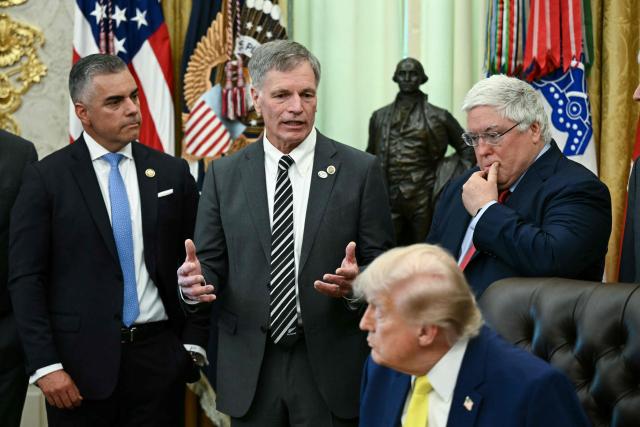 US President Donald Trump listens as Wyoming Governor (2L) speaks during an announcement about coal, in the Oval Office of the White House in Washington, DC on June 4, 2026. President Trump on Thursday announced he was using Cold War era legislation to tap $700 million in funding for a slew of coal plants and mines and an export terminal. (Photo by Brendan SMIALOWSKI / AFP)