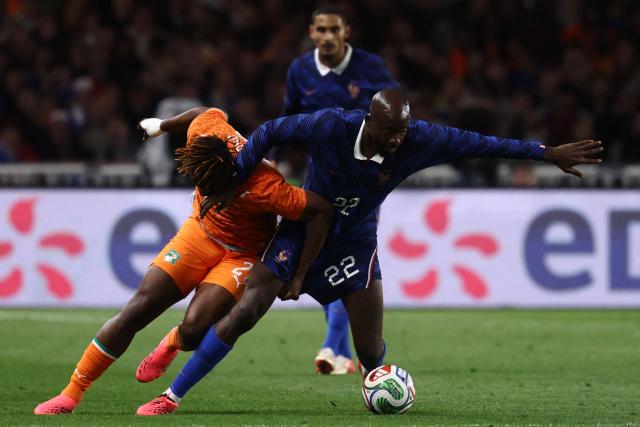 Ivory Coast's defender #20 Emmanuel Agbadou (L) and France's forward #22 Jean Mateta (R) fight for the ball during the international friendly football match between France and Ivory Coast ahead of the 2026 FIFA World Cup football tournament at the Stade de la Beaujoire in Nantes, western France, on June 4, 2026. (Photo by FRANCK FIFE / AFP)