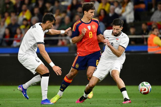 Spain's forward #08 Gonzalo Garcia and Iraq's midfielder #19 Kevin Yakob (R) vie for the ball during the international friendly football match between Spain and Iraq ahead of the 2026 FIFA World Cup football tournament, at the Riazor stadium in A Coruna, northern Spain, on June 4, 2026. (Photo by Ander Gillenea / AFP)