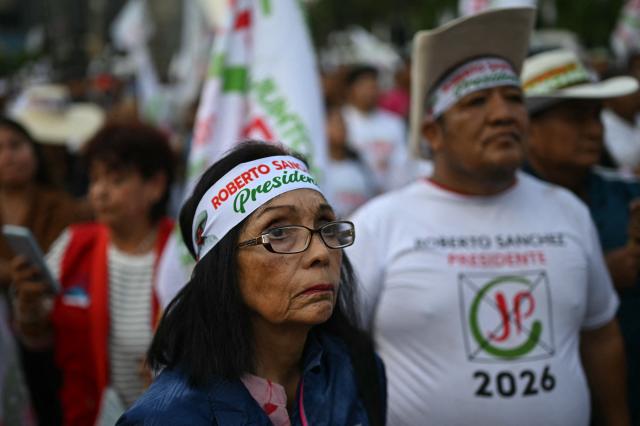 Supporters of Peru's presidential candidate for the Juntos por el Peru party, Roberto Sanchez, wait for the start of his closing campaign rally in Lima on June 4, 2026. Right-wing candidate Keiko Fujimori and leftist Roberto Sanchez will face off in Peru's presidential runoff on June 7, 2026. (Photo by ERNESTO BENAVIDES / AFP)