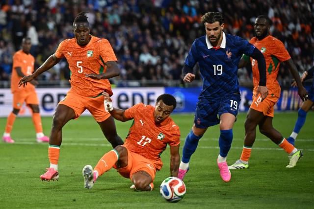 Ivory Coast's defender #05 Wilfried Stephane Singo (L), Ivory Coast's defender #17 Guela Doue (C) and France's defender #19 Theo Hernandez (R) fight for the ball during the international friendly football match between France and Ivory Coast ahead of the 2026 FIFA World Cup football tournament at the Stade de la Beaujoire in Nantes, western France, on June 4, 2026. (Photo by Loic VENANCE / AFP)