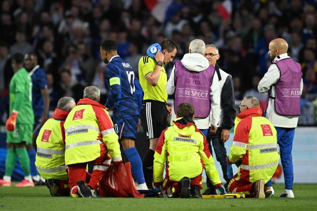 Swiss referee Sebastian Gishamer receives medical attention during the international friendly football match between France and Ivory Coast ahead of the 2026 FIFA World Cup football tournament at the Stade de la Beaujoire in Nantes, western France, on June 4, 2026. (Photo by Loic VENANCE / AFP)
