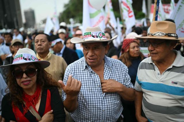 Supporters of Peru's presidential candidate for the Juntos por el Peru party, Roberto Sanchez, wait for the start of his closing campaign rally in Lima on June 4, 2026. Right-wing candidate Keiko Fujimori and leftist Roberto Sanchez will face off in Peru's presidential runoff on June 7, 2026. (Photo by ERNESTO BENAVIDES / AFP)