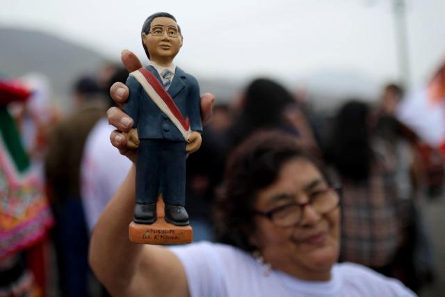 A supporter of Peru’s presidential candidate for the Fuerza Popular party, Keiko Fujimori, holds a toy depicting former president Alberto Fujimori as she waits for the candidate’s arrival at a closing campaign rally in Lima on June 4, 2026. Right-wing candidate Keiko Fujimori and leftist Roberto Sanchez will face off in Peru's presidential runoff on June 7, 2026. (Photo by Anthony NINO DE GUZMAN / AFP)