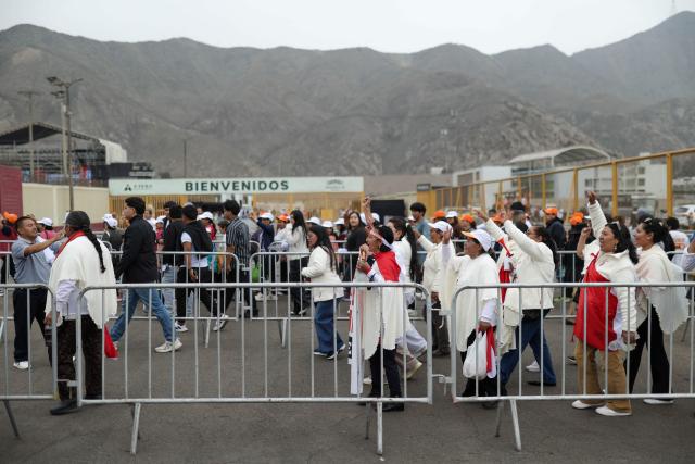 Supporters of Peru's presidential candidate for the Fuerza Popular party, Keiko Fujimori, walk amid security fences on arrival for her closing campaign rally in Lima on June 4, 2026. Right-wing candidate Keiko Fujimori and leftist Roberto Sanchez will face off in Peru's presidential runoff on June 7, 2026. (Photo by Anthony Nino de Guzman / AFP)