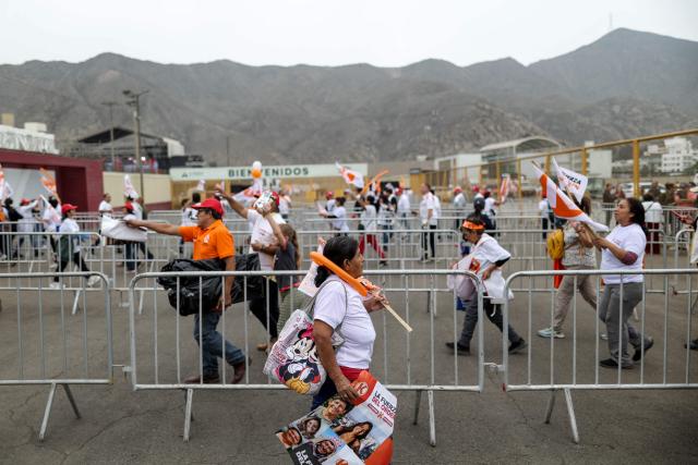 Supporters of Peru's presidential candidate for the Fuerza Popular party, Keiko Fujimori, walk amid security fences on arrival for her closing campaign rally in Lima on June 4, 2026. Right-wing candidate Keiko Fujimori and leftist Roberto Sanchez will face off in Peru's presidential runoff on June 7, 2026. (Photo by Anthony Nino de Guzman / AFP)