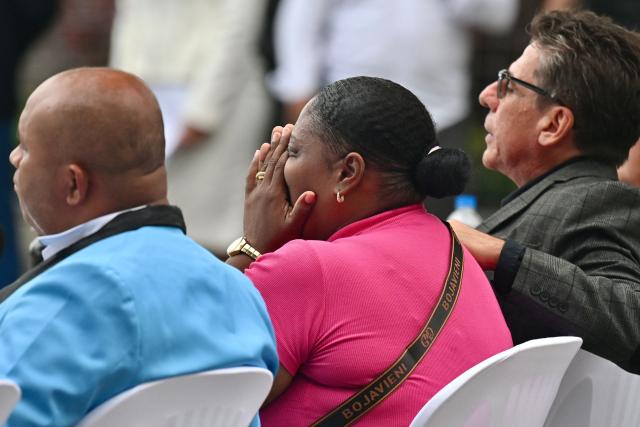 Johanna Arboleda (C), mother of Nehemias Arboled, reacts during a public apology event on behalf of the Ecuadorian government for the forced disappearance of the four children from the Malvinas, at the Rotonda hemicycle in Guayaquil, Ecuador, on June 4, 2026. (Photo by MARCOS PIN / AFP)