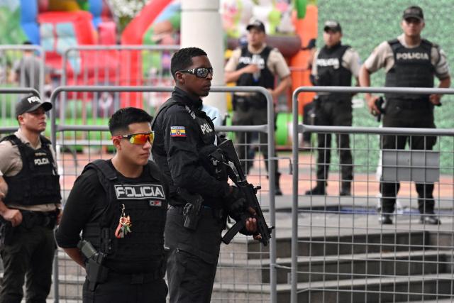 Ecuadorian police officers stand guard during a public apology event on behalf of the Ecuadorian government for the forced disappearance of the four children from the Malvinas, at the Rotonda hemicycle in Guayaquil, Ecuador, on June 4, 2026. (Photo by MARCOS PIN / AFP)