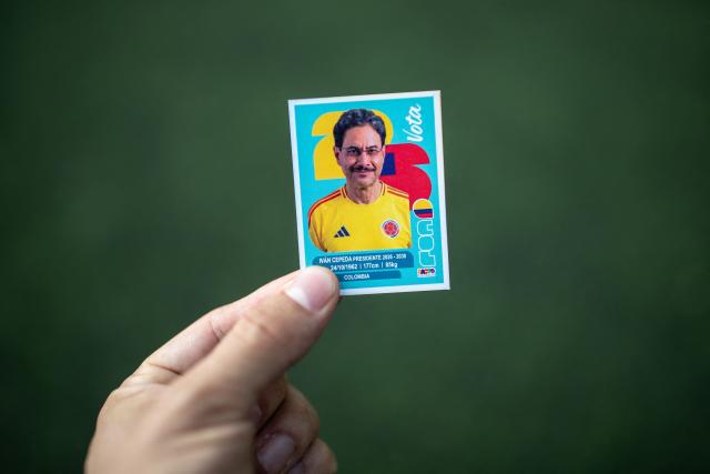 A Panini FIFA World Cup sticker depicting Colombia's presidential candidate for the Pacto Historico Party, Ivan Cepeda, is pictured during a campaign rally with organized football fan supporters in Bogota on June 4, 2026. Colombia will hold the runoff presidential election on June 21. (Photo by AFP)