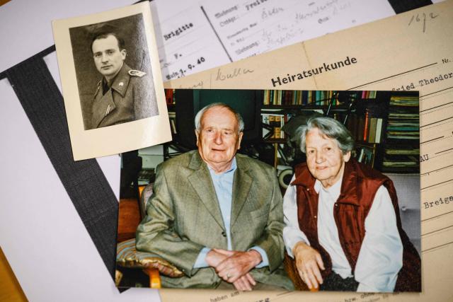 This photo taken on June 2, 2026 shows a picture (C) of German lecturer Felix Puelm’s grandparents Paul and Brigitte, a small picture (top L) of Paul in army uniform, their marriage certificate (R), and (bottom, white paper) a copy of a National Socialist German Workers’ party (NSDAP) membership card of his grandmother Brigitte that he found in an online database published by Die Zeit, a German national weekly newspaper, at Silpakorn University, in Nakhon Pathom province, west of Bangkok. (Photo by ANTHONY WALLACE / AFP)