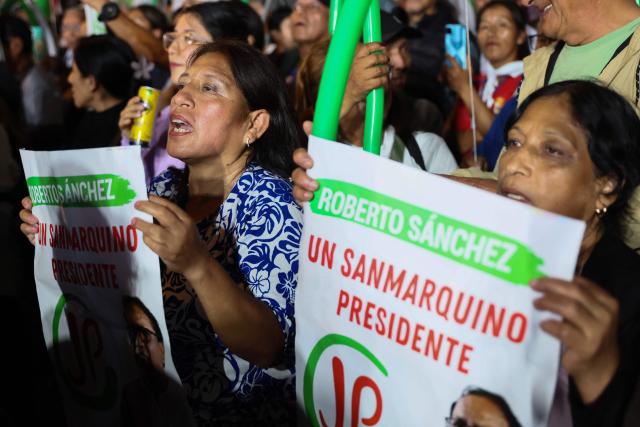 Supporters of Peru's presidential candidate for the Juntos por el Peru party, Roberto Sanchez, hold signs as they wait for the start of his closing campaign rally in Lima on June 4, 2026. Right-wing candidate Keiko Fujimori and leftist Roberto Sanchez will face off in Peru's presidential runoff on June 7, 2026. (Photo by Connie FRANCE / AFP)