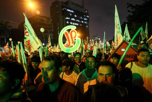 Supporters of Peru's presidential candidate for the Juntos por el Peru party, Roberto Sanchez, wait for the start of his closing campaign rally in Lima on June 4, 2026. Right-wing candidate Keiko Fujimori and leftist Roberto Sanchez will face off in Peru's presidential runoff on June 7, 2026. (Photo by Connie FRANCE / AFP)