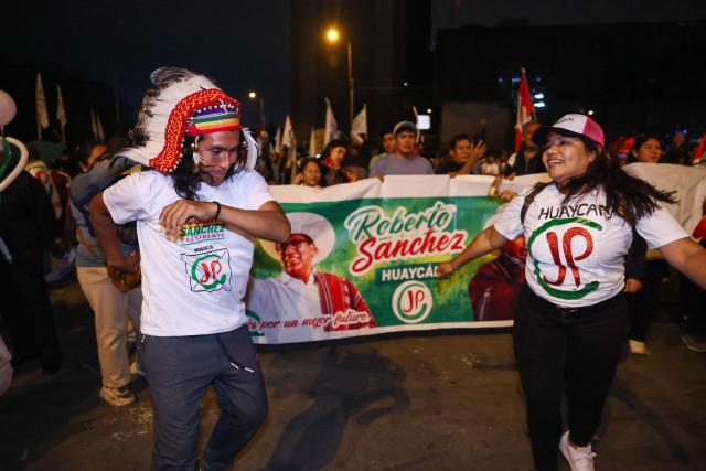 Supporters of Peru's presidential candidate for the Juntos por el Peru party, Roberto Sanchez, dance as they wait for the start of his closing campaign rally in Lima on June 4, 2026. Right-wing candidate Keiko Fujimori and leftist Roberto Sanchez will face off in Peru's presidential runoff on June 7, 2026. (Photo by Connie FRANCE / AFP)