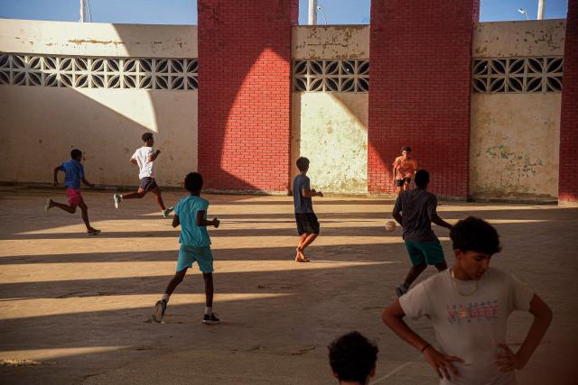 Teenagers play football inside a deteriorated sports facility in Havana on June 4, 2026. (Photo by AFP)