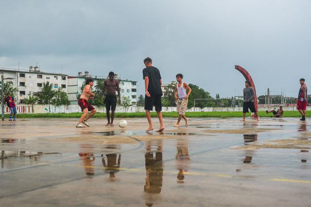 Teenagers play football on an abandoned basketball court in Havana on June 4, 2026. (Photo by AFP)