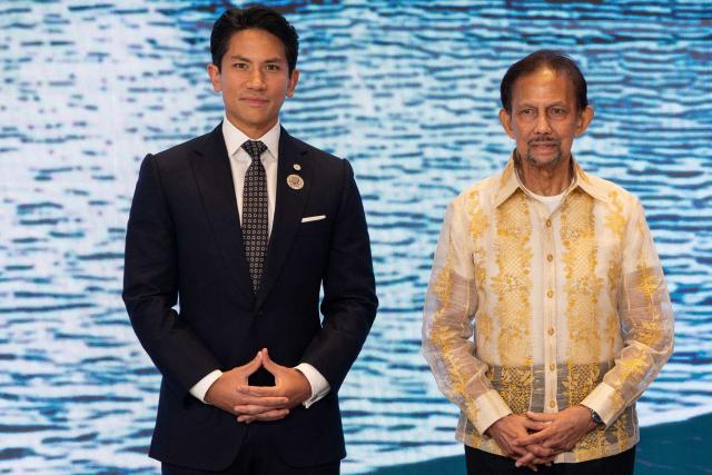 (FILES) Brunei's Sultan Hassanal Bolkiah (R) and his son Prince Abdul Mateen pose for photos ahead of the gala dinner at the 48th Association of Southeast Asian Nations (ASEAN) summit in Cebu, central Philippines, on May 8, 2026. Brunei's Sultan Hassanal Bolkiah has named one of his youngest sons, Abdul Mateen, as foreign minister in a major cabinet reshuffle -- largely seen as a move to prepare for the next generation of leaders in the oil-rich kingdom. (Photo by Eloisa Lopez / POOL / AFP)