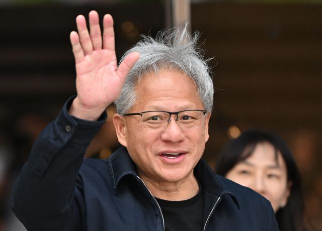 Nvidia CEO Jensen Huang waves to the media as he arrives at Gimpo airport in Seoul on June 5, 2026. (Photo by Jung Yeon-je / AFP)
