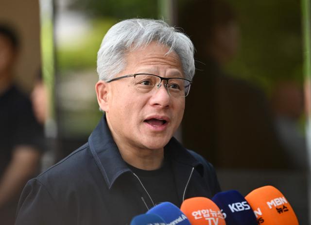 Nvidia CEO Jensen Huang speaks to reporters as he arrives at Gimpo airport in Seoul on June 5, 2026. (Photo by Jung Yeon-je / AFP)