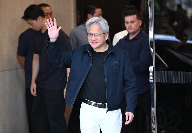 Nvidia CEO Jensen Huang waves to the media as he arrives at Gimpo airport in Seoul on June 5, 2026. (Photo by Jung Yeon-je / AFP)