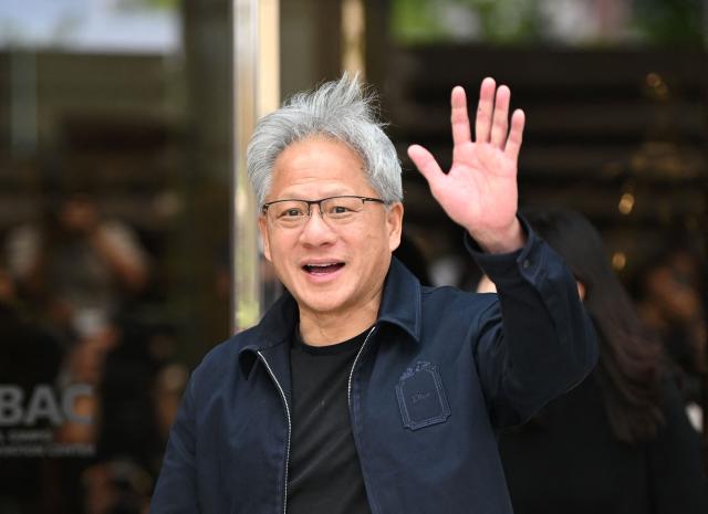 Nvidia CEO Jensen Huang waves to the media as he arrives at Gimpo airport in Seoul on June 5, 2026. (Photo by Jung Yeon-je / AFP)