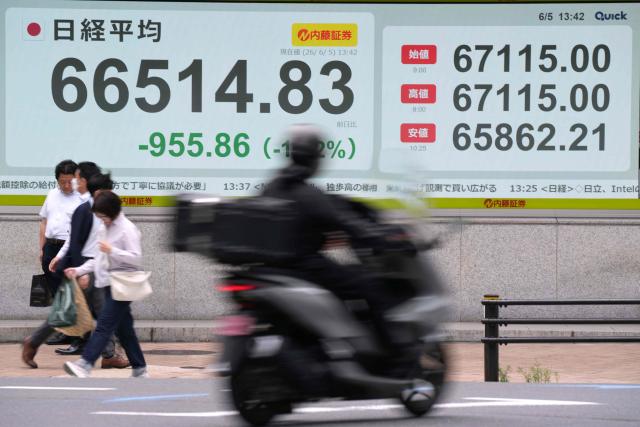 Electronic quotation boards display the Nikkei Stock Average on the Tokyo Stock Exchange along a street in Tokyo on June 5, 2026. (Photo by Kazuhiro NOGI / AFP)