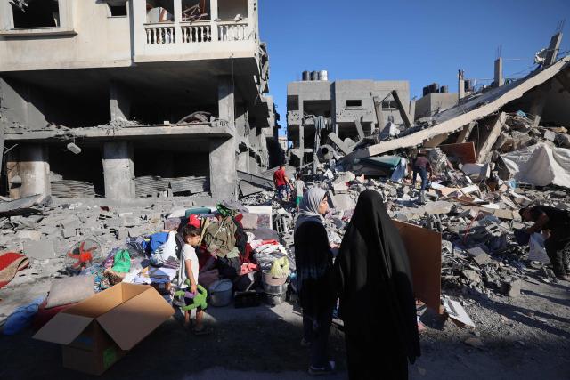 Palestinian clear debris at the site of an Israeli strike on a house whose residents were warned to evacuate before the attack, in  Zawaida central Gaza Strip on June 5, 2026. Despite a truce technically in effect since October 2025, daily violence has rocked the Gaza Strip, over half of which is under Israeli military control in defiance of the ceasefire's terms. Israel has killed at least 936 people since the ceasefire began, according to Gaza's health ministry, which operates under Hamas authority and whose figures are considered reliable by the UN. (Photo by Eyad Baba / AFP)