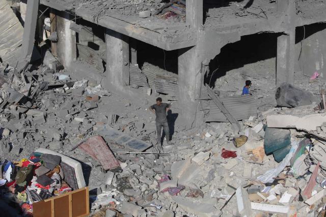 Palestinians stand amid debris at the site of an Israeli strike on a house whose residents were warned to evacuate before the attack, in Zawaida central Gaza Strip on June 5, 2026. Despite a truce technically in effect since October 2025, daily violence has rocked the Gaza Strip, over half of which is under Israeli military control in defiance of the ceasefire's terms. Israel has killed at least 936 people since the ceasefire began, according to Gaza's health ministry, which operates under Hamas authority and whose figures are considered reliable by the UN. (Photo by Eyad Baba / AFP)