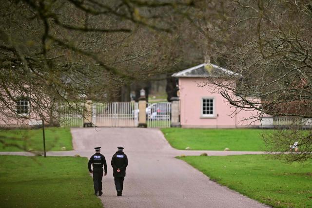 (FILES) Police officers walk towards the entrance to Royal Lodge, a 30-room property and former residence to Britain's former prince Andrew where police said they are still conducting a search, in Windsor, west of London on February 20, 2026, a day after Andrew Mountbatten-Windsor was arrested on the royal family's remote Sandringham estate in eastern England. The disgraced former prince Andrew earned a private income from subletting cottages while paying a symbolic "peppercorn rent" for a mansion for over two decades, the UK government auditor revealed June 5, 2026. (Photo by Ben STANSALL / AFP)