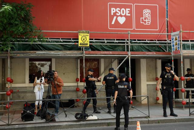 (FILES) Spanish National Police officers stand guard outside the ruling Spanish Socialist Party (PSOE) headquarters after agents from the UCO, the Civil Guard unit specializing in complex and sensitive investigations, entered the premises to demand documents, in Madrid, on May 27, 2026. Spanish police entered the Madrid headquarters of the ruling Socialist party today to request documents as part of a probe into alleged illegal party financing, judicial and police sources said. The operation adds to mounting pressure on Prime Minister Pedro Sanchez after former Socialist prime minister, Jose Luis Rodriguez Zapatero, was put under formal investigation last week for influence peddling and other crimes in another case. (Photo by Oscar DEL POZO / AFP)