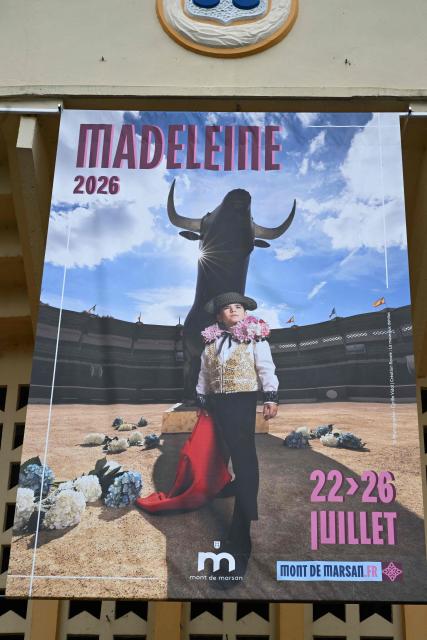 A poster is displayed at the entrance of the Plumacon bullring announcing the upcoming Madeleine festival in Mont-de-Marsan, southwestern France, on June 4, 2026. The poster, featuring the five-year-old daughter of former torero Thomas Dufau dressed as a bullfighter (torera), sparked controversy among anti-bullfighting groups — including a tribune signed by French singer Renaud, author Annie Ernaux and philisopher Elisabeth Badinter — who unsuccessfully sought its removal in court on June 1. (Photo by Gaizka IROZ / AFP)