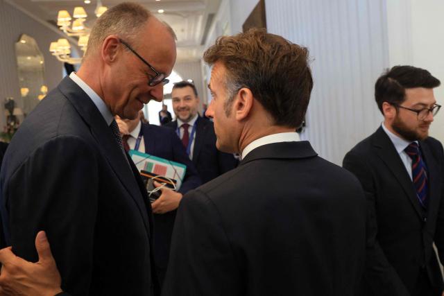 German Chancellor Friedrich Merz (L) and French President Emmanuel Macron (R) speak ahead of a meeting as part of the EU-Western Balkans Summit at Porto Montenegro in Tivat on June 5, 2026. (Photo by Ludovic MARIN / AFP)