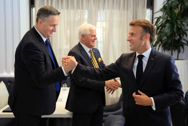 Chairman of the Presidency of Bosnia and Herzegovina Denis Becirovic (L) shakes hands with French President Emmanuel Macron (R) ahead of a meeting as part of the EU-Western Balkans Summit at Porto Montenegro in Tivat on June 5, 2026. (Photo by Ludovic MARIN / AFP)
