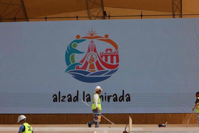 Workers install the stage ahead of Pope Leo XIV's upcoming trip to Madrid, part of a six day trip to Spain, on Lima square in Madrid on June 6, 2026. Pope Leo XIV is scheduled to begin a seven-day Apostolic trip to Spain on June 6, including stops in Madrid where he will hold a mass in Cibeles Square, Barcelona where he is to hold a mass in the iconic Sagrada Familia cathedral and inaugurate the tower of Jesus Christ, and the Canary Islands where he will meet with migrants and organisations dedicated to helping them. (Photo by Pierre-Philippe MARCOU / AFP)