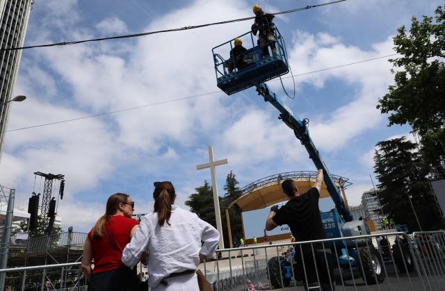 Workers install the stage ahead of Pope Leo XIV's upcoming trip to Madrid, part of a six day trip to Spain, on Lima square in Madrid on June 6, 2026. Pope Leo XIV is scheduled to begin a seven-day Apostolic trip to Spain on June 6, including stops in Madrid where he will hold a mass in Cibeles Square, Barcelona where he is to hold a mass in the iconic Sagrada Familia cathedral and inaugurate the tower of Jesus Christ, and the Canary Islands where he will meet with migrants and organisations dedicated to helping them. (Photo by Pierre-Philippe MARCOU / AFP)