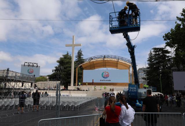 Workers install the stage ahead of Pope Leo XIV's upcoming trip to Madrid, part of a six day trip to Spain, on Lima square in Madrid on June 6, 2026. Pope Leo XIV is scheduled to begin a seven-day Apostolic trip to Spain on June 6, including stops in Madrid where he will hold a mass in Cibeles Square, Barcelona where he is to hold a mass in the iconic Sagrada Familia cathedral and inaugurate the tower of Jesus Christ, and the Canary Islands where he will meet with migrants and organisations dedicated to helping them. (Photo by Pierre-Philippe MARCOU / AFP)